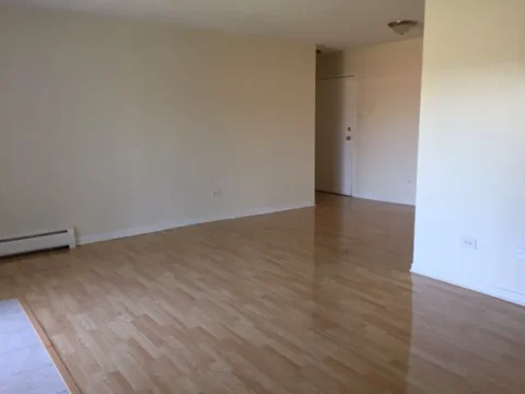 A large open living space with wooden floors.